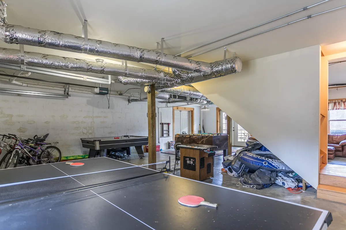 This recreational space features a ping pong table, bicycles, and a casual seating area, creating a lively atmosphere for group games and shared laughter. The vibe is playful and relaxed, perfect for a large group or family wanting to create memories together.